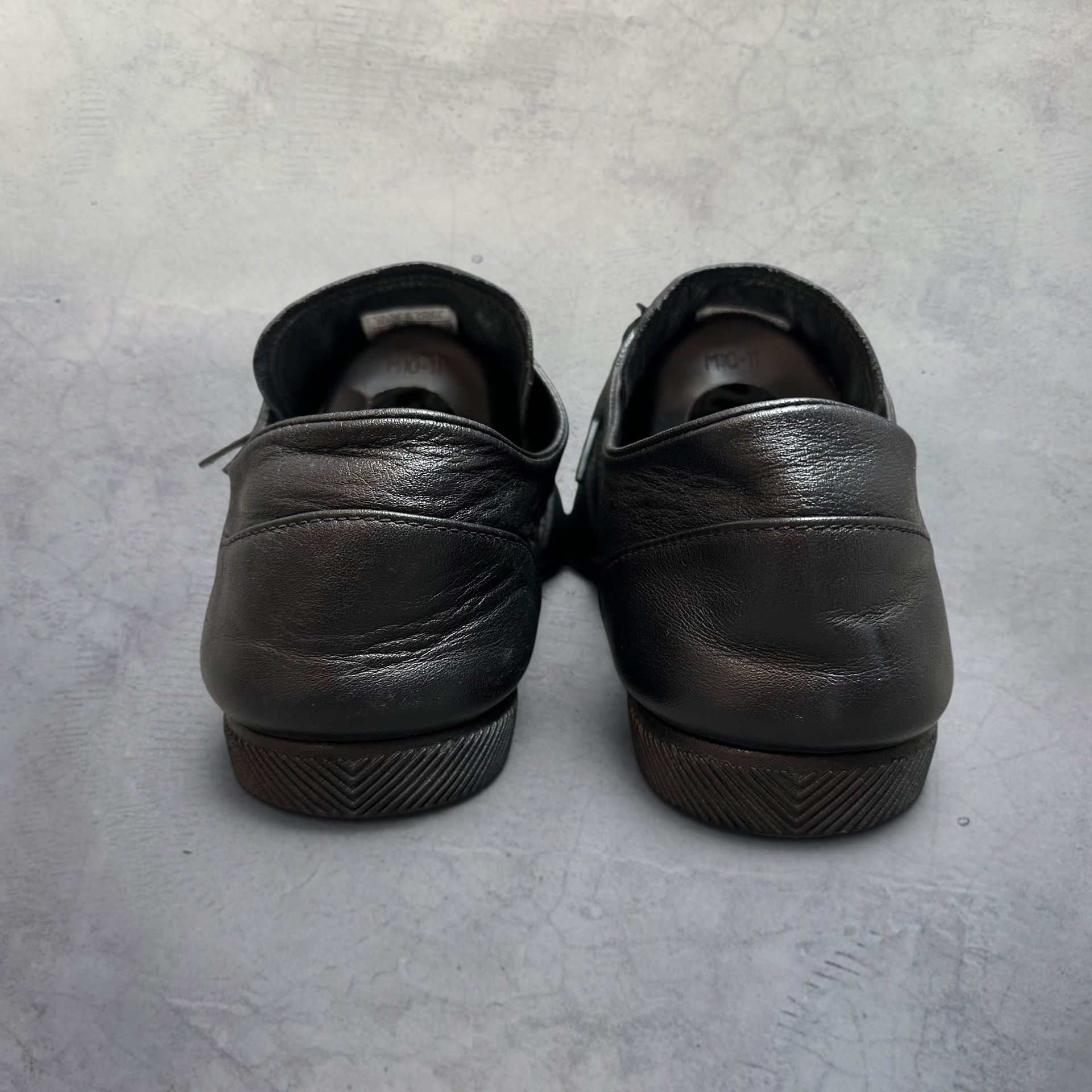 SĀN ARCHIVE GOODS Adidas Y-3 Japan triple black leather sneakers, rear view showing low-profile rubber cupsole.